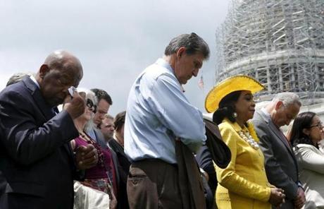 US Representative John Lewis (left) wiped his eye as members of Congress prayed outside US Capitol.
