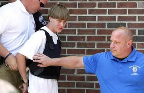 Police led suspected shooter Dylann Roof into a courthouse in Shelby, N.C., on Thursday.
