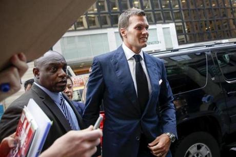 New England Patriots quarterback Tom Brady (C) arrives at NFL headquarters as people ask for autographs in New York June 23, 2015. Tom Brady's appeal of his four-game National Football League suspension for participating in a scheme to deflate footballs during last season's playoffs begins Tuesday at NFL headquarters in New York. REUTERS/Shannon Stapleton
