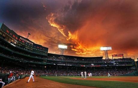 Storm clouds provided a colorful backdrop as Red Sox hosted the Orioles at Fenway.
