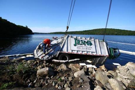 Crews worked to remove the garbage truck from Lake Cochichewick in North Andover.
