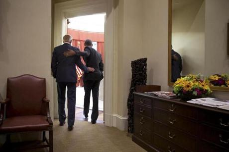 President Barack Obama and Vice President Joe Biden embrace while walking into the Oval Office, shortly before Obama was to deliver remarks on the Supreme Court?s ruling on King v. Burwell.
