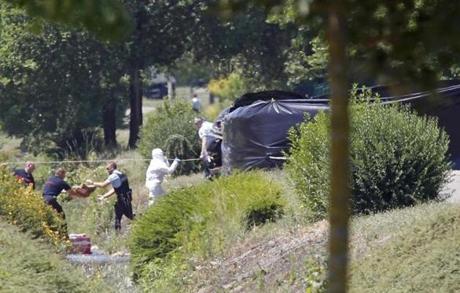 Crime scene investigators were seen at work next to a black plastic sheet outside a gas company site in Saint-Quentin-Fallavier, southeast of Lyon.

