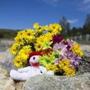 Flowers and a stuffed animal were left near where a girl?s body was found on Deer Island Thursday. 
