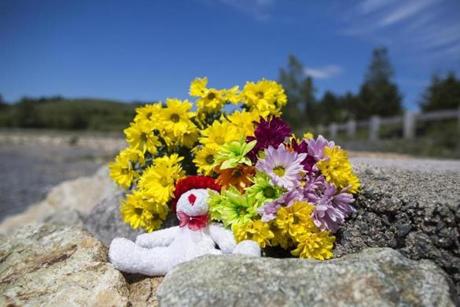 Flowers and a stuffed animal were left near where a girl?s body was found on Deer Island Thursday. 
