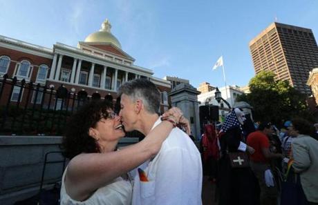 Liz Nania, at left and Sandy Bailey, at right, celebrated the Supreme Court?s ruling on same-sex marriage and their one year wedding anniversary on the State House steps during a rally Friday evening. 
