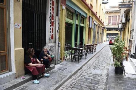 Employees of a restaurant talk on an empty street in the northern Greek port city of Thessaloniki, Tuesday, June 30, 2015. Greek Finance Minister Yanis Varoufakis confirmed that the country will not make its payment due later to the International Monetary Fund. Capital controls began Monday and will last at least a week, an attempt to keep the banks from collapsing in the face of a nationwide bank run. (AP Photo/Giannis Papanikos) 
