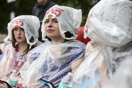 Martha Murphy and her mother Jodie Murphy (right) used plastic bags while waiting out the rain.
