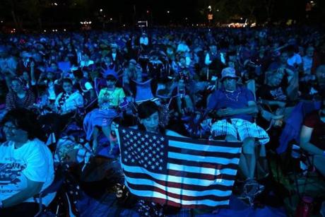 People took in the light show as the Boston Pops performed Saturday.
