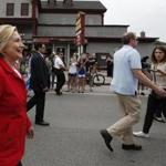 Members of the media were kept behind a moving rope line as Democratic presidential candidate Hillary Rodham Clinton marched in a Fourth of July parade. 