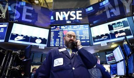 A trader talked on a phone at the New York Stock Exchange after trading was halted.
