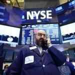 A trader talked on a phone at the New York Stock Exchange after trading was halted.