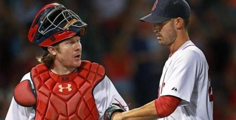 07/08/15: Boston, MA: Red Sox catcher Ryan Hanigan (left) has a fist pump and some words for starting pitcher Rick Porcello (right ) as they head for the dugout following the final out of the top of the sixth inning, the last frame for Porcello. The Boston Red Sox hosted the Miami Marlins in an inter league MLB baseball game at Fenway Park. (Globe Staff Photo/Jim Davis) section:sports topic:Red Sox-Marlins (1)
