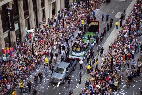 Fans of the US women?s soccer team cheer during the ticker-tape parade to celebrate their World Cup win. 
