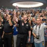 Jim Green, NASA Planetary Science Division director (center), guests, and other New Horizons team members counted down to the spacecraft?s closest approach to Pluto at the Johns Hopkins University Applied Physics Laboratory early Tuesday.