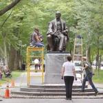 Rika Smith McNally (front) and her crew work on the William Lloyd Garrison statue on the Commonwealth Avenue Mall.