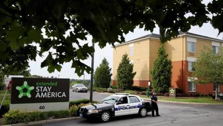 A Burlington police officer stood earlier this month at the entrance of the Extended Stay America hotel, where the body of Sanisha Johnson was found. 
