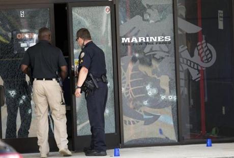Police officers entered the Armed Forces Career Center through a bullet-riddled door.  
