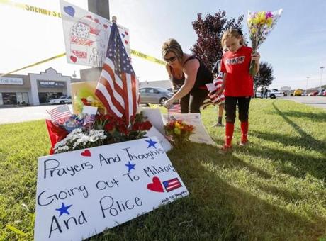 A family brought flowers to a makeshift memorial near the recruiting center in Chattanooga, Tenn., where an attack left four Marines dead.
