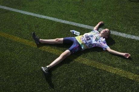 Atriathlon competitor crossed the finish line during the annual kids event at MIT on Sunday. 
