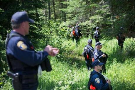 Law enforcement personel search for David Sweat and Richard Matt on June 25.
