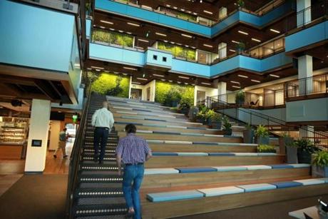 At TripAdvisor?s new headquarters building in Needham, an open atrium serves as both stairway and meeting place.
