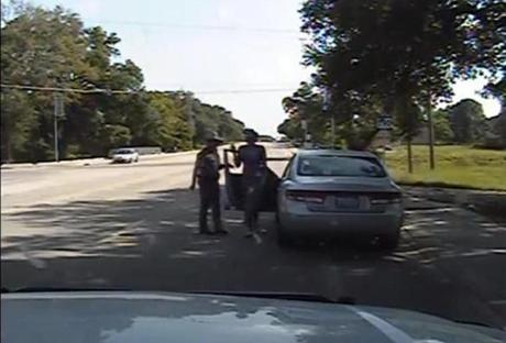This screen capture shows Texas state trooper Brian Encinia (left) next to the car as Sandra Bland, 28, gets out of her vehicle following a traffic stop for allegedly failing to signal a lane change earlier this month.

