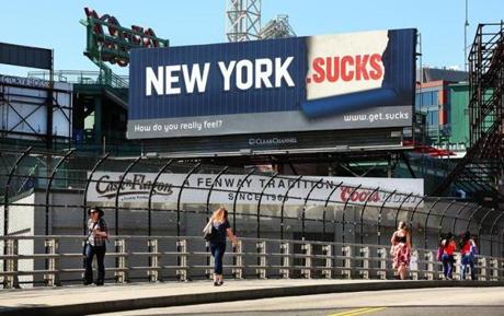 A pitch for a Vox Populi domain is splashed across a billboard near Fenway Park overlooking the Massachusetts Turnpike. 
