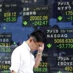 A man walked past an electronic stock board at a Tokyo securities firm on Monday.