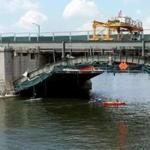 Kayakers passed under the Longfellow Bridge as it undergoes a restoration project.