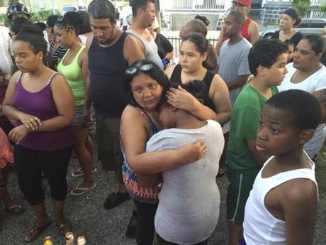 Luz Sanchez, foreground, mother of shooting victim Grisel Sanchez, attended a vigil Wednesday night, hugging unidentified friend. Grisel Sanchez's daughter, Idalys Vasquez, is pictured at far left.
