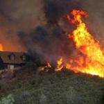 Flames approached a house on Friday in Lower Lake, California. More than 900 firefighters are battling the Rocky Fire that covered more than 15,000 acres since it started on Wednesday afternoon.