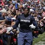 New England Patriots strong safety Jordan Richards slaps hands with fans during an NFL football training camp in Foxborough, Mass., Friday, July 31, 2015. (AP Photo/Charles Krupa)