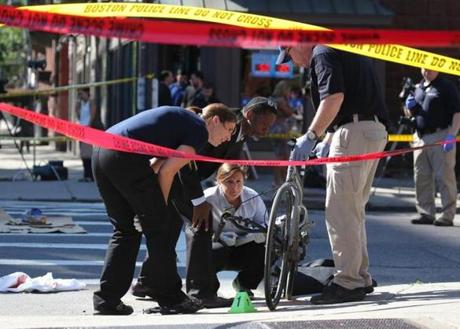 Police and crime investigators were on the scene after a bicyclist killed Friday when she was hit by a tractor-trailer near the intersection of Beacon Street and Massachusetts Avenue.
