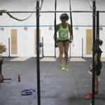 Jessa Lemoine 28, of Boston, practiced on the rings at CrossFit Lando in advance of the first match last year of the new National Pro Grid League.