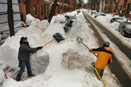 In February, Boston had no place to put new snow. Jose Luis Bavahona (left) and Pawel Szymanski shoveled out.
