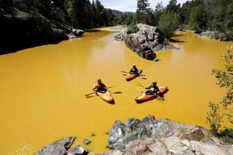 People kayaked in the Animas River near Durango, Colo., on Thursday, in water colored from a mine waste spill.
