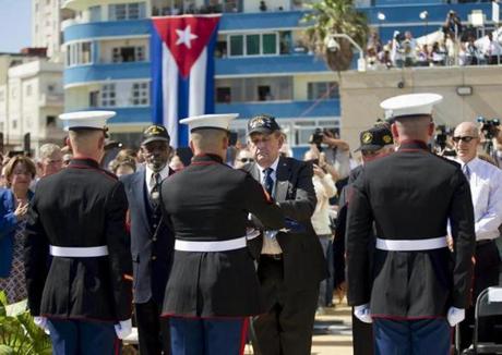 (Left to right) Retired Marines Francis ?Mike? East, James Tracy, and Larry Morris presented the US flag to Marines currently stationed in Cuba on Friday.
