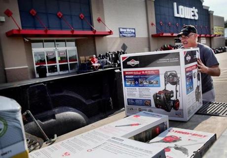 Mike Adams of Norwell loaded his truck on Saturday morning at a Lowe's in Pembroke. He said he thinks he saved about $110 as he bought a pair of generators, a pressure washer and a weed whacker. 
