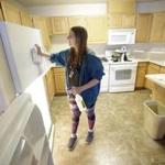 Student Emilee Gull recently cleaned a dorm room at Southern Utah University in Cedar City, Utah. An enrollment boom has created a housing crisis at the university.
