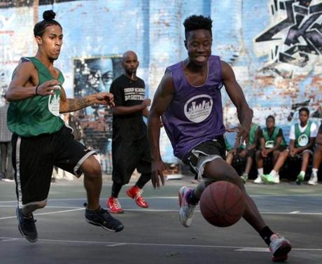 Devante Cartagena (left) looked to stop Nvayamo Cherif?s run down the court at the Blackstone Community Center in the South End.
