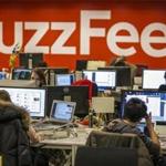 The BuzzFeed logo is displayed on the wall as employees work in the newsroom at the company's headquarters in their Midtown Manhattan offices in New York in this January 9, 2014 file photo. The growing Internet-based economy has rapidly changed New York City's property and employment landscape, spurring a rebirth of century-old landmark buildings for office space and the tightest U.S. commercial real estate market since the financial downturn. The city's pace of job creation is at its fastest in 65 years, and it has lifted leasing by companies in the technology, media and advertising sectors to overtake the traditional lease leader of accounting, financial and legal services in a once-overlooked submarket: Manhattanâ??s trendy Midtown South area. Picture taken January 9, 2014. REUTERS/Brendan McDermid/Files 