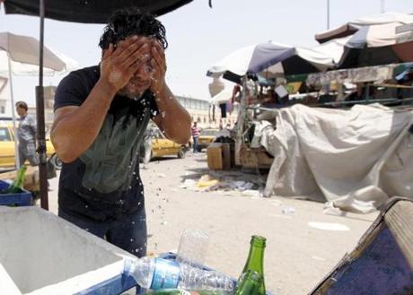 A man washed his face to cool off during a warm summer day in Baghdad last July.
