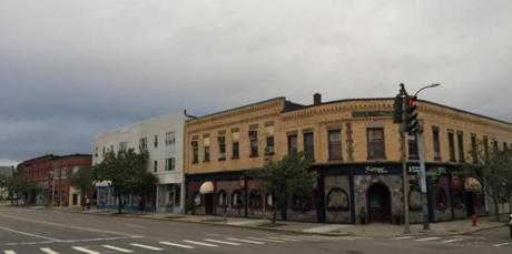 A developer is seeking a permit from Newton?s Historical Commission to raze a block of buildings in Newtonville.
