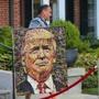 A worker carried a painting of Donald Trump to the side of Ernie Boch Jr.?s Norwood house.