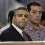 In this June file photo, Canadian Al-Jazeera English journalist Mohammed Fahmy, left, and his Egyptian colleague Baher Mohammed listened in a courtroom in Tora prison in Cairo, Egypt. 