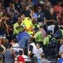Fans watched as emergency medical personnel tended to a fan who fell from an upper deck at Turner Field during a game between the Yankees and the Braves on Saturday.