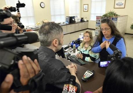 Rowan County Clerk Kim Davis (right) talked with David Moore following her office's refusal to issue marriage licenses.
