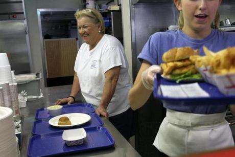 Labor Day weekend may be the busiest stretch of summer at the Clam Box, where owner Chickie Aggelakis (left) supervised as Mackenzie Colbert served.
