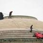Workers removed items from MIT's Great Dome on Friday.